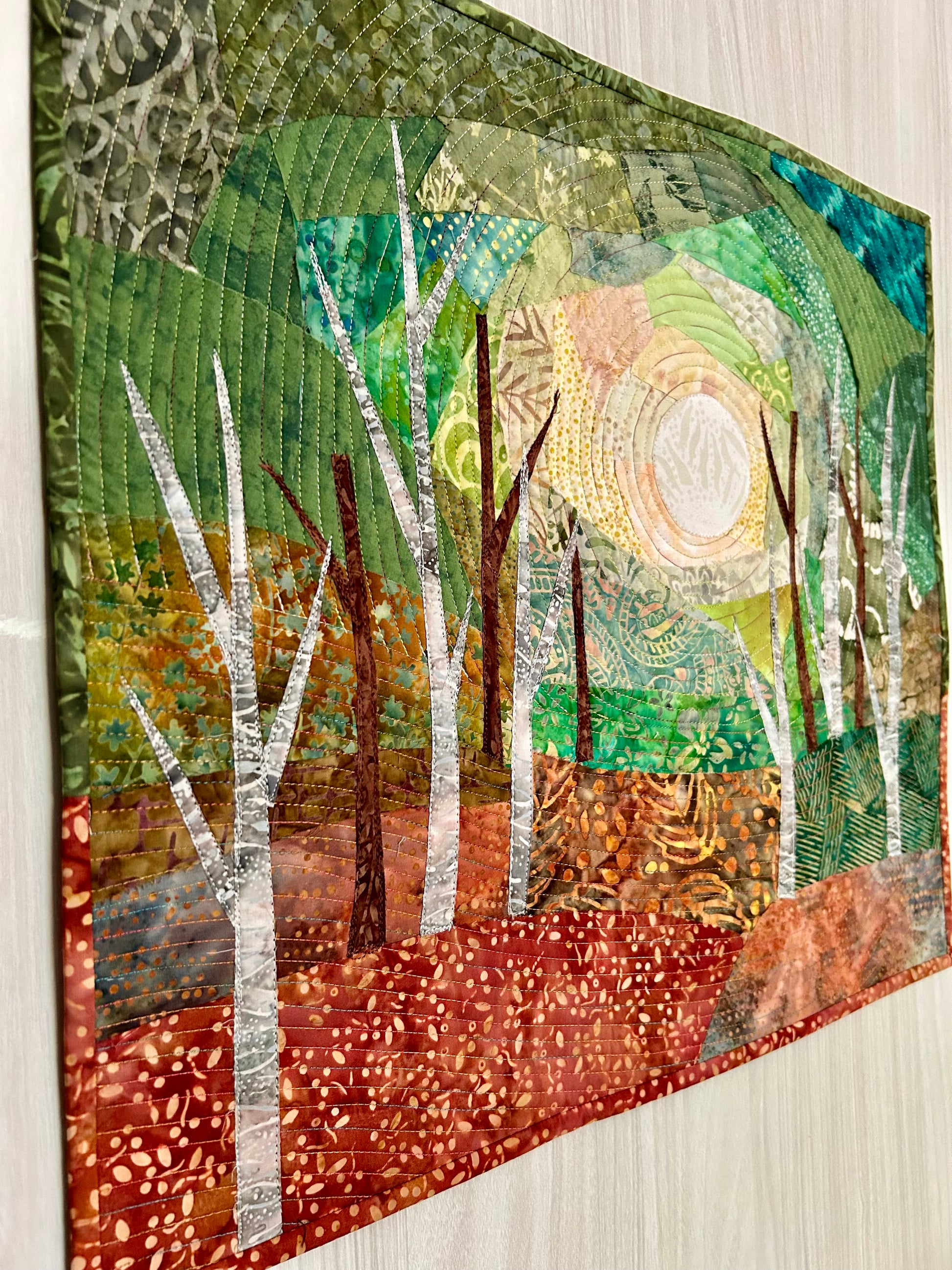 Side angled view of jungle art quilt