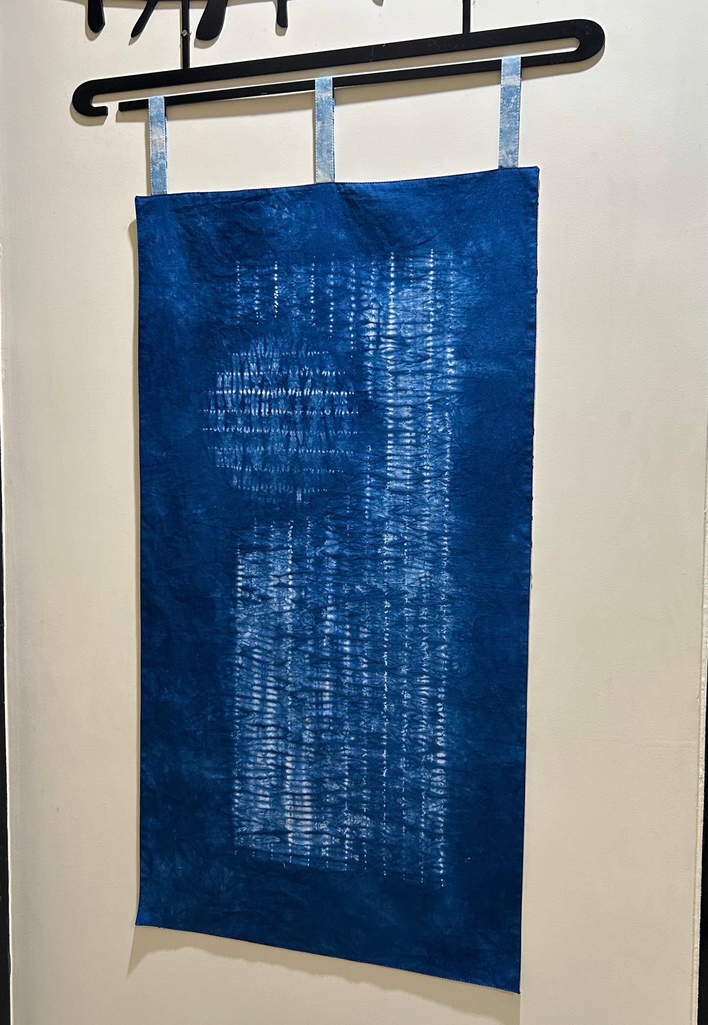 Side view of nui technique hand dyed indigo shibori panel