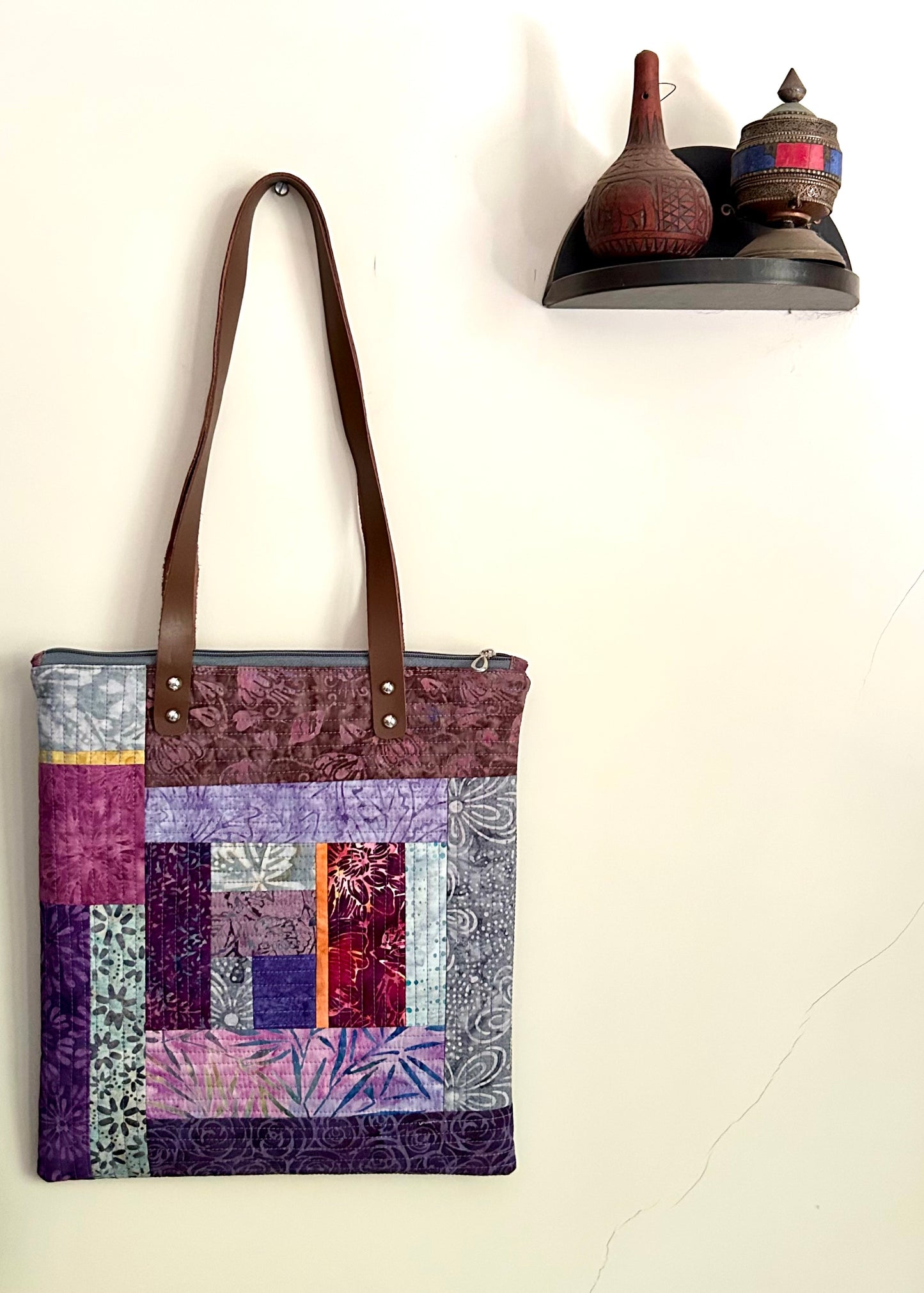 Purple quilted tote bag with leather straps