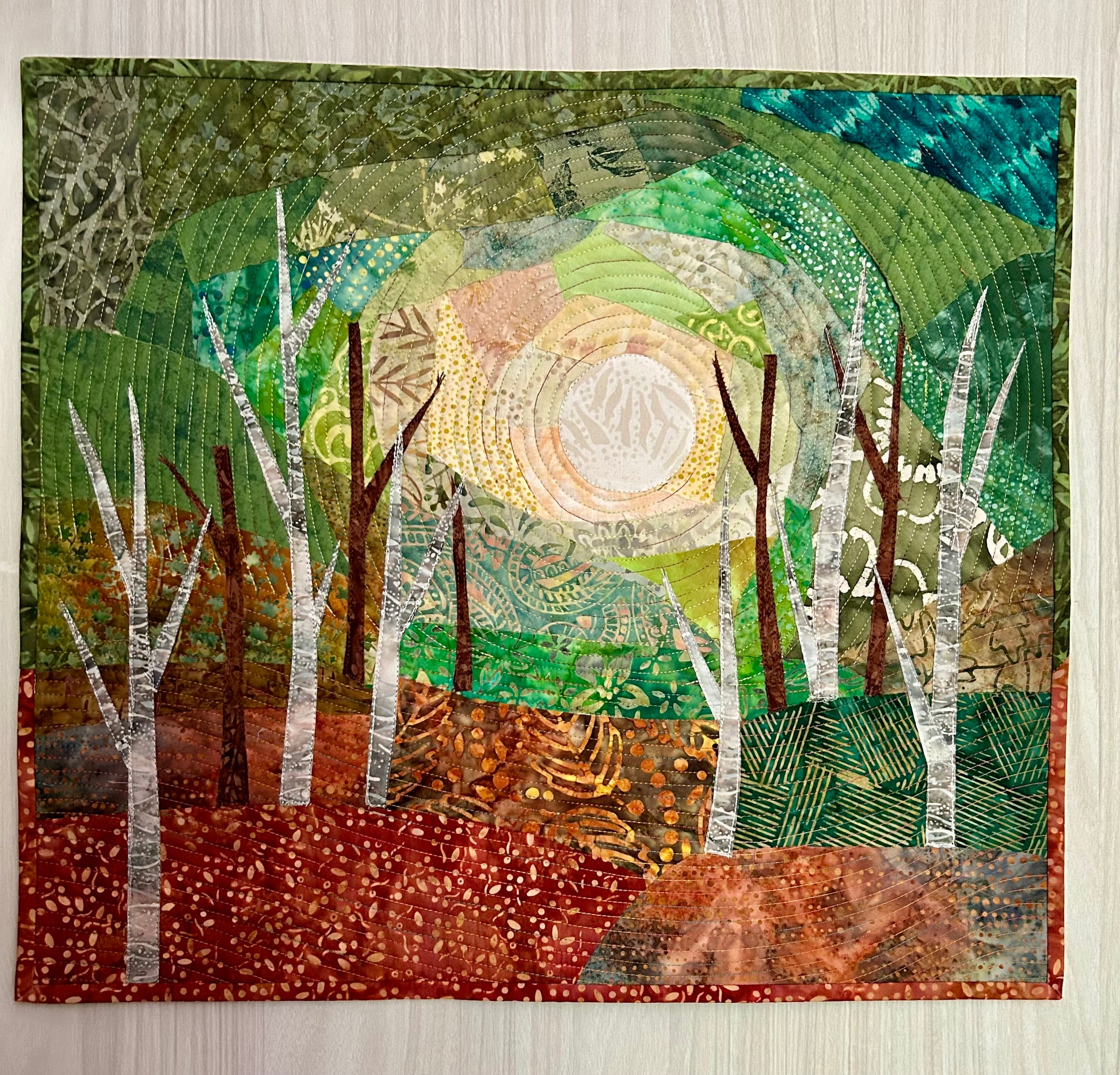 Framable landscape fiber art quilt titled Into the Woods