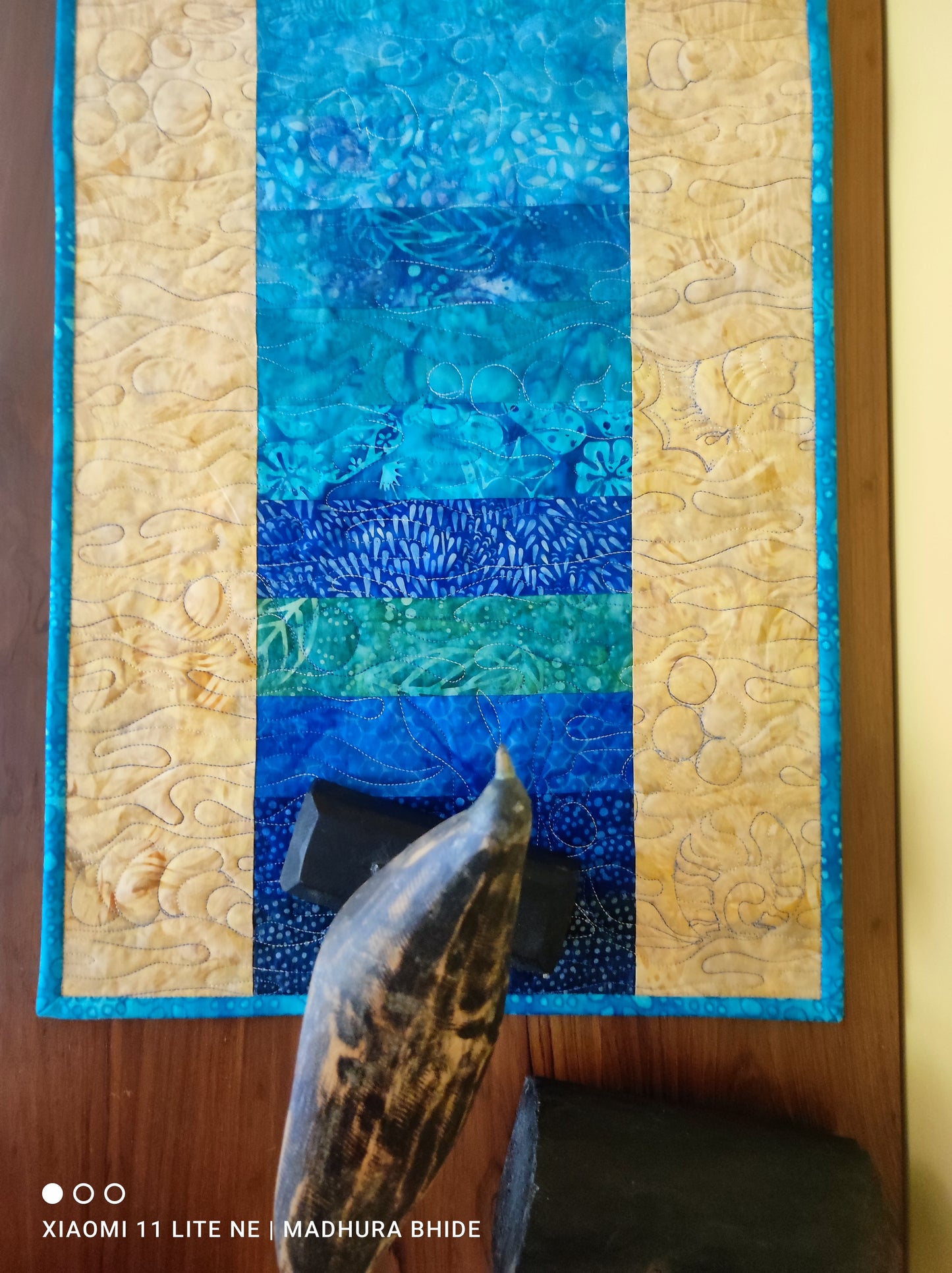 Close-up of ocean wave motifs on quilted table runner