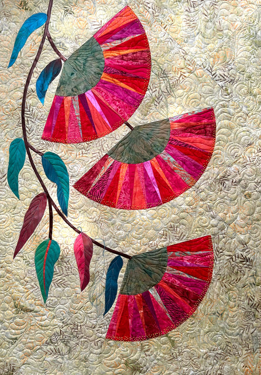 Handmade quilt featuring Australian gumnut flowers in red and orange, set against Bali batik fabric background.