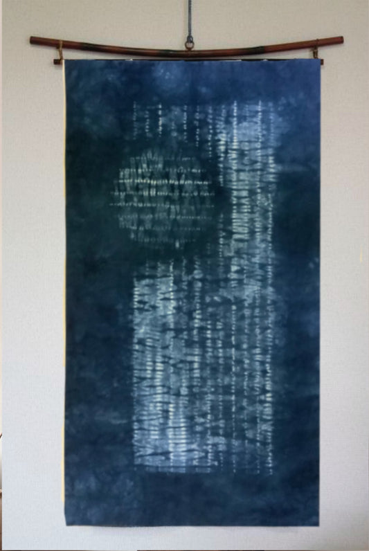 Indigo Japanese Shibori wall hanging displayed on a white wall