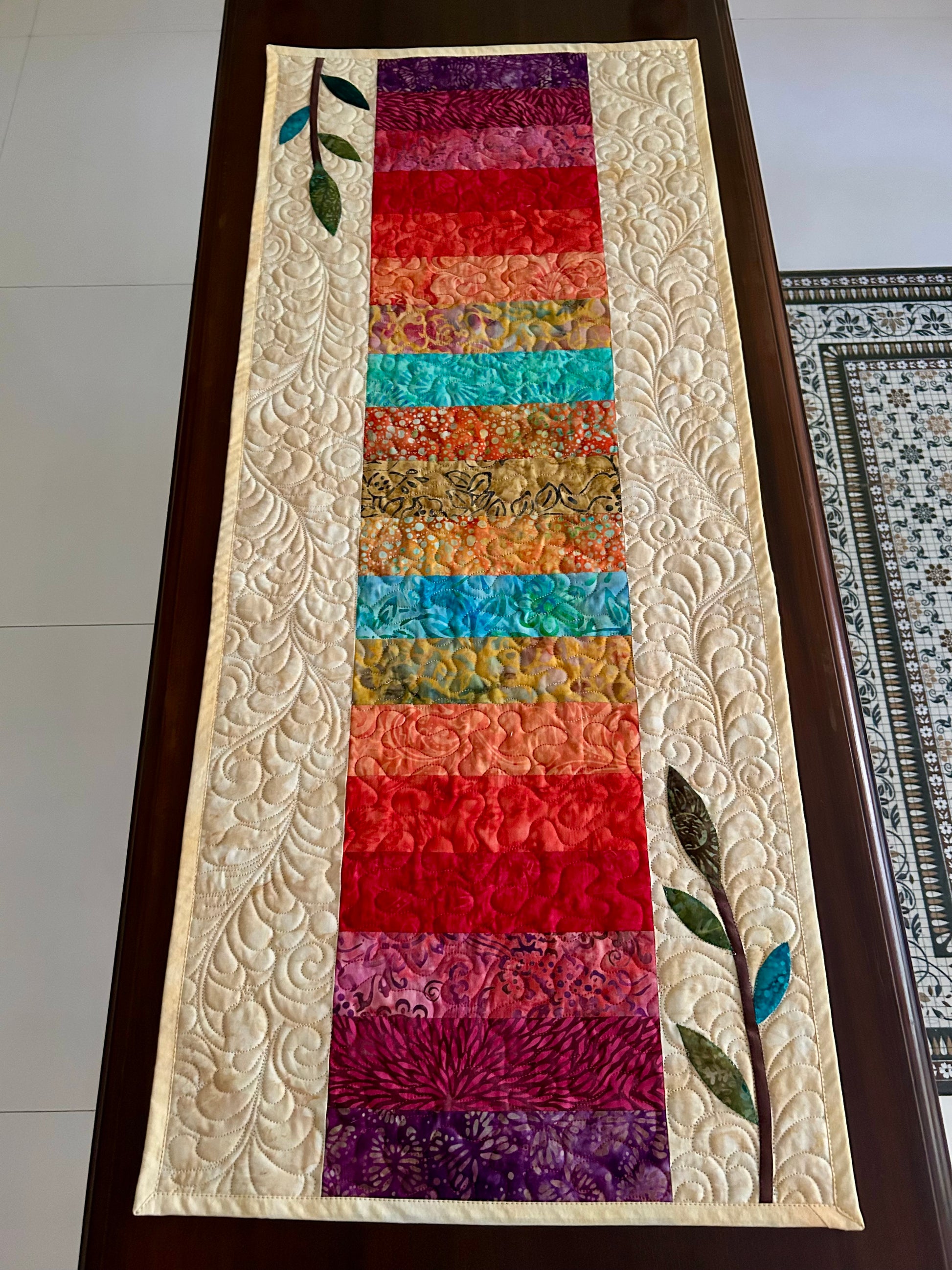 Close-up of vibrant batik fabrics in rainbow table runner