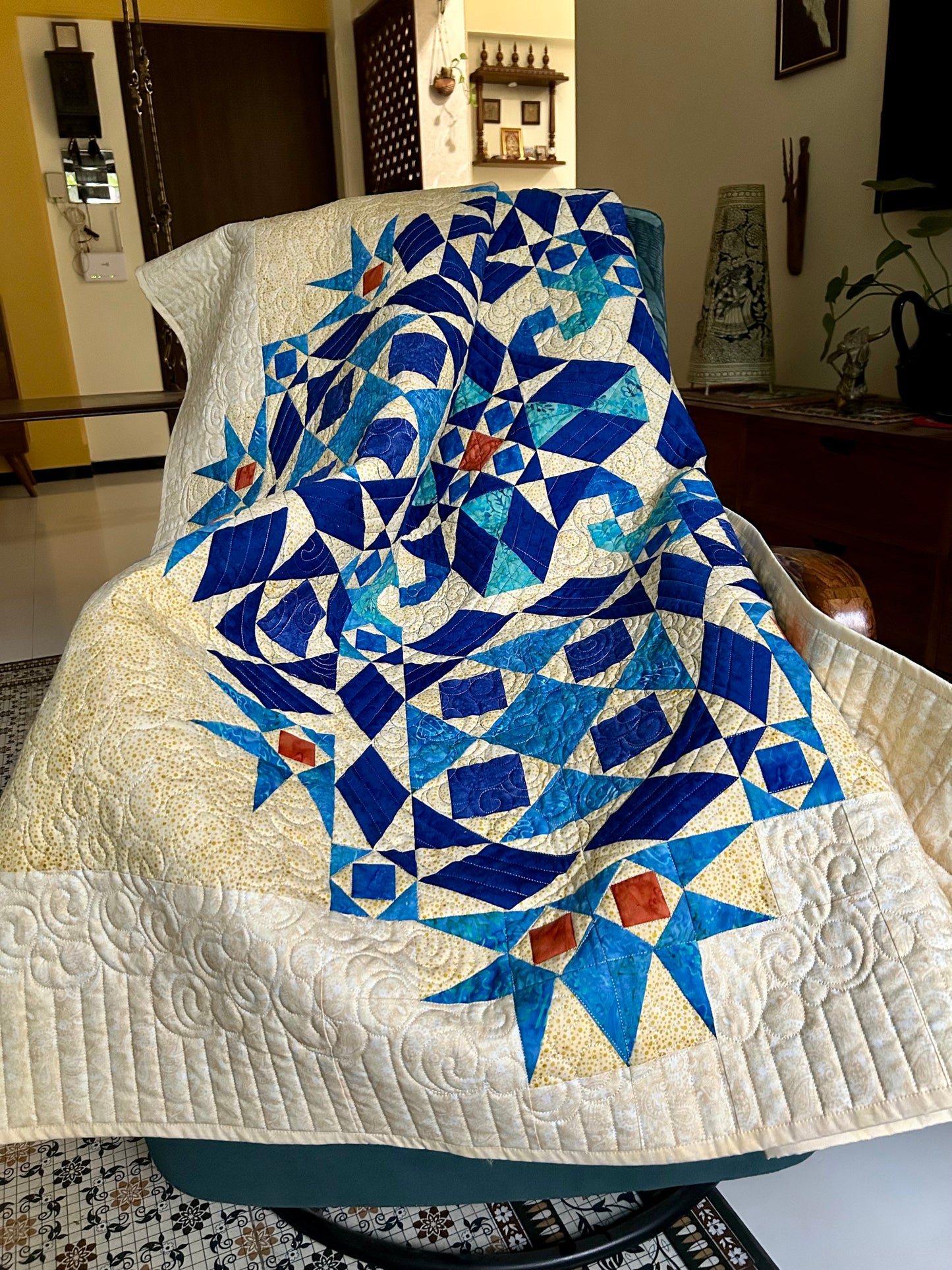 Nautical-themed handmade quilt laid out on couch