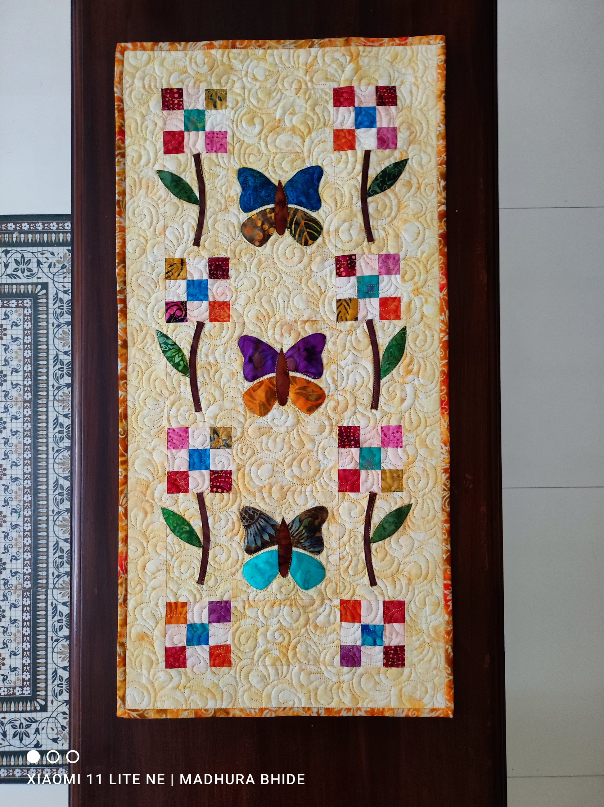 Handmade butterfly patchwork table runner on wooden dining table