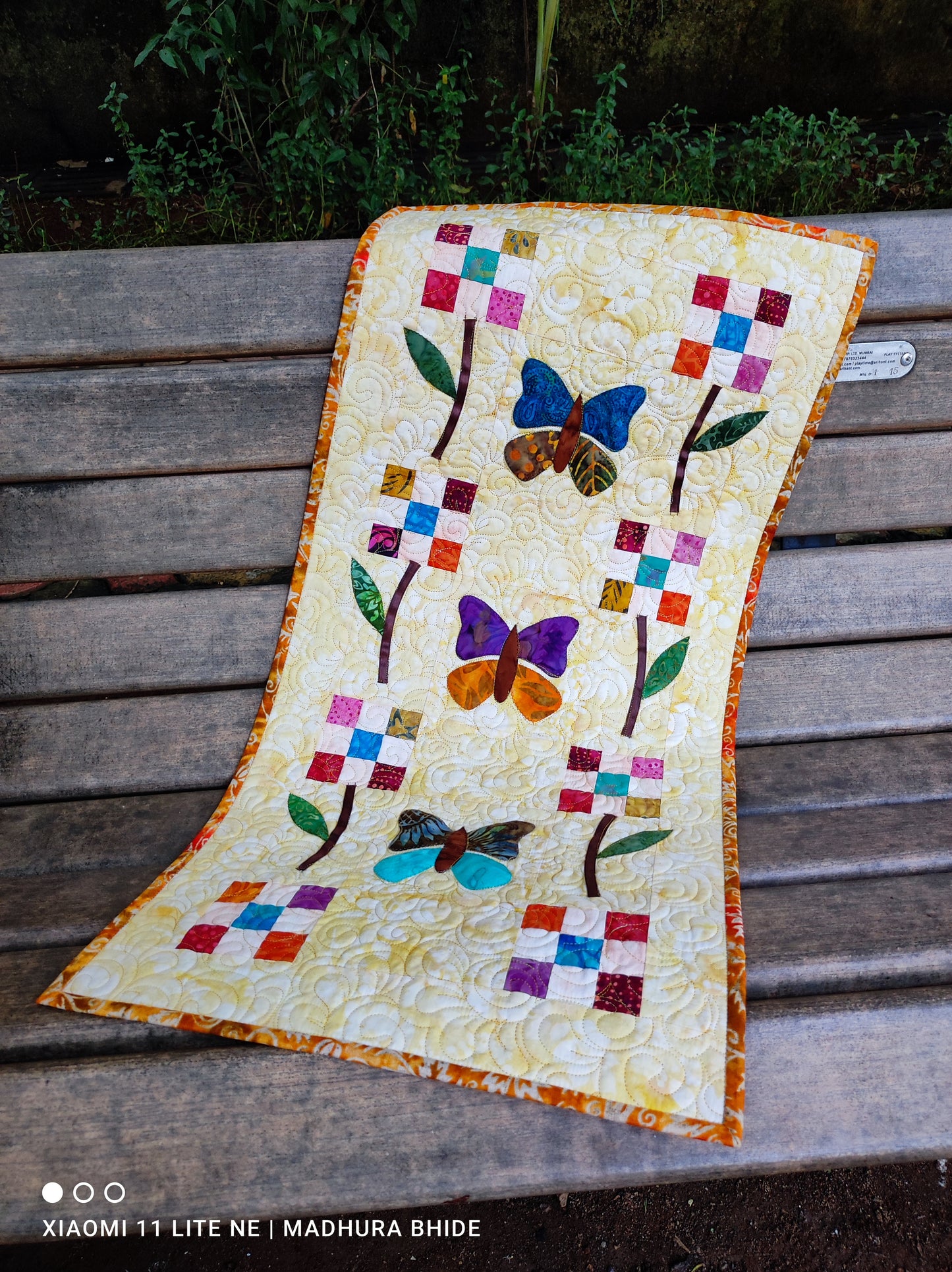 Bright patchwork table runner with handmade stitching