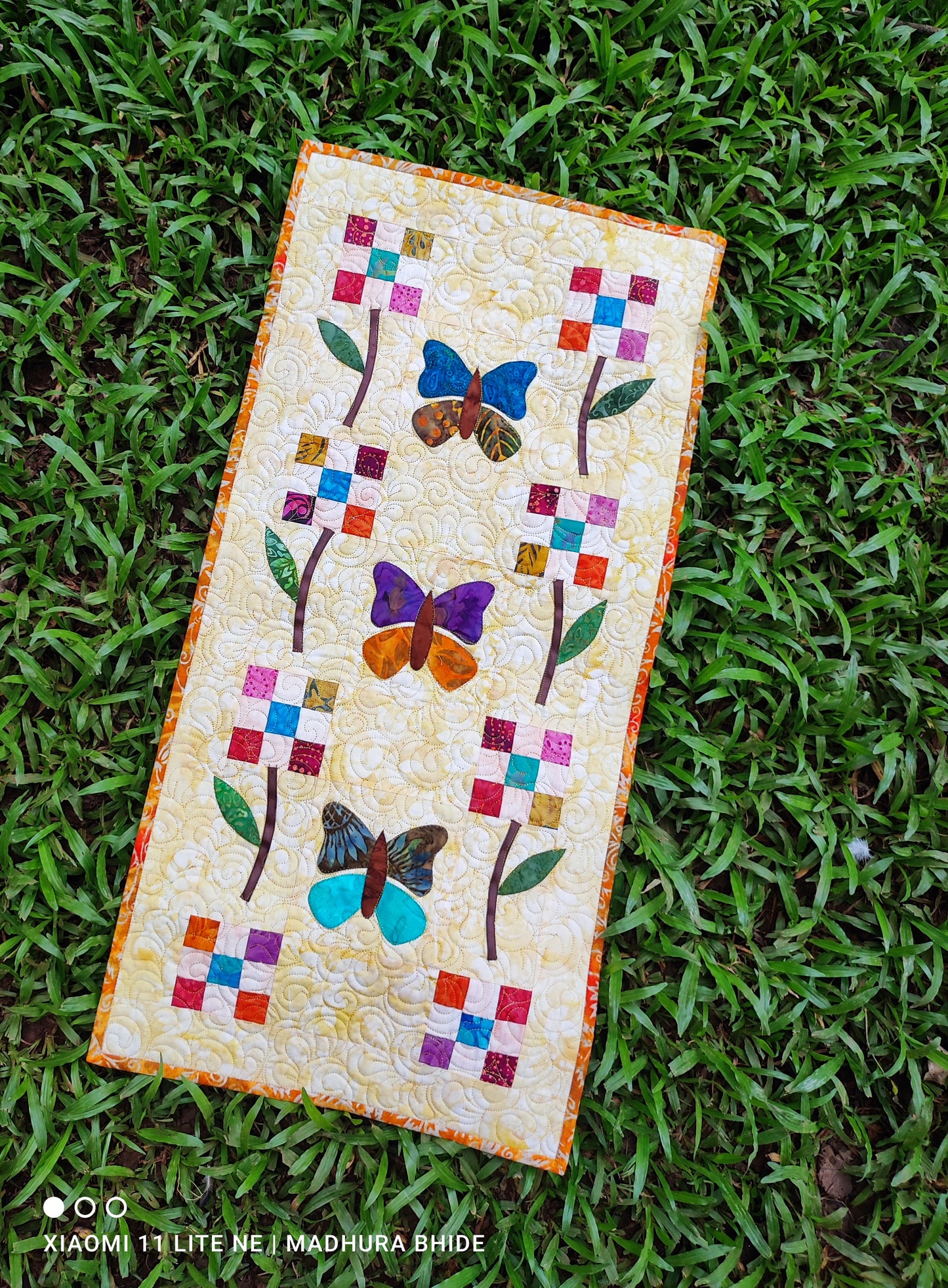 Spring-themed table decor with quilted table runner