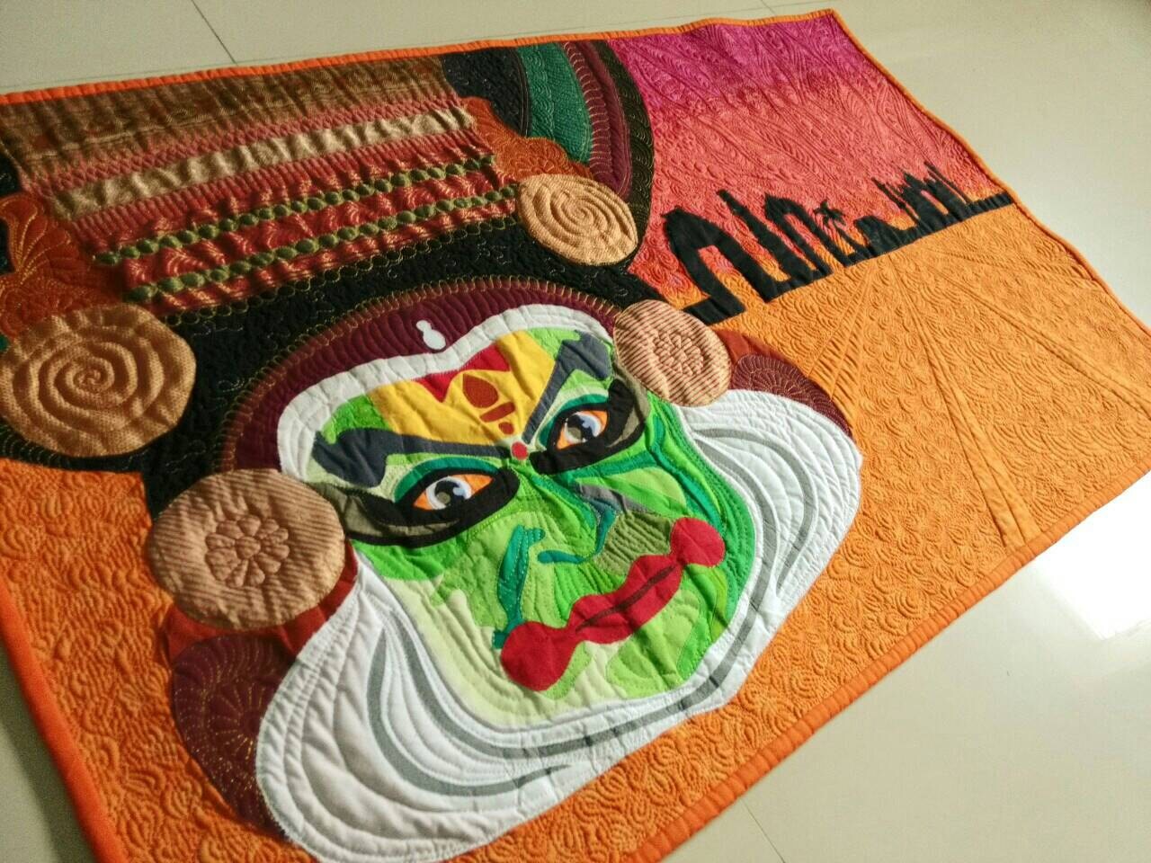 Close-up of expressive Kathakali face and stitching detail.