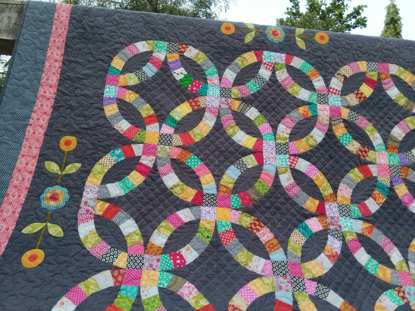 Quilting details on gray queen size wedding ring quilt