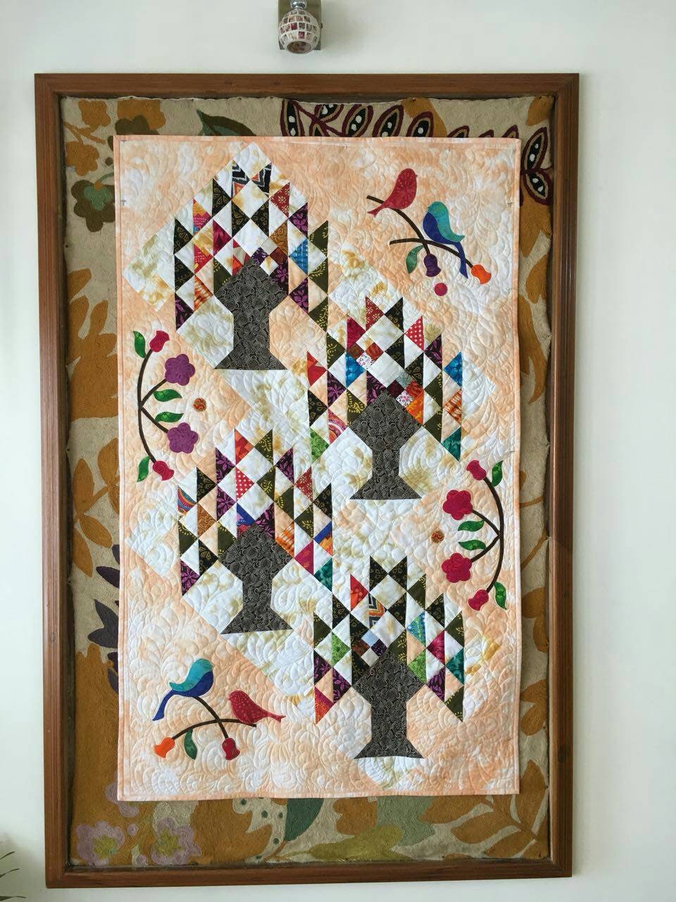 Colourful tree of life quilt hanging