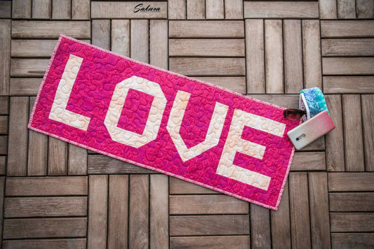 Love table runner on wooden floor