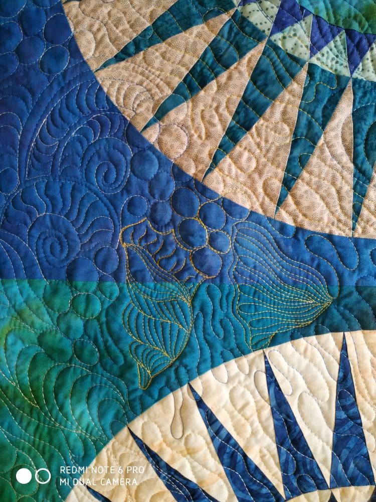 Details of quilting sic he’s on blue ocean art