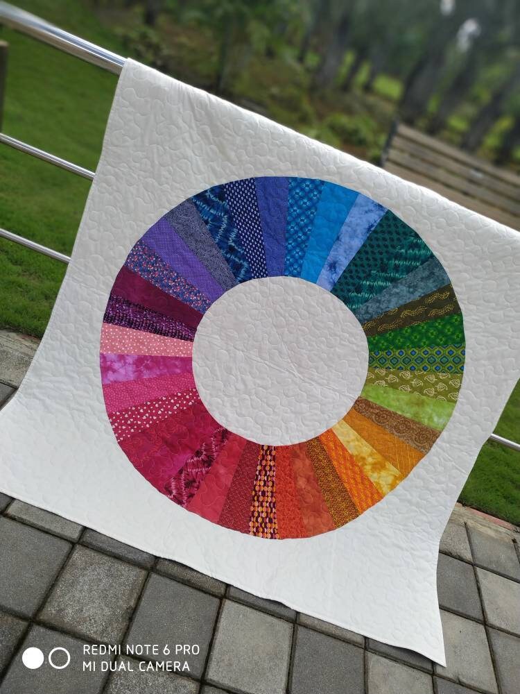 Multicolor geometric patchwork quilt In natural light