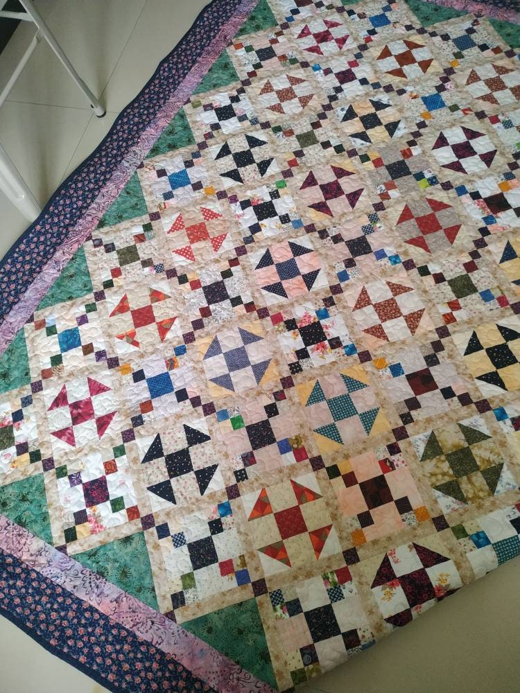 Side view of scrappy queen size quilt