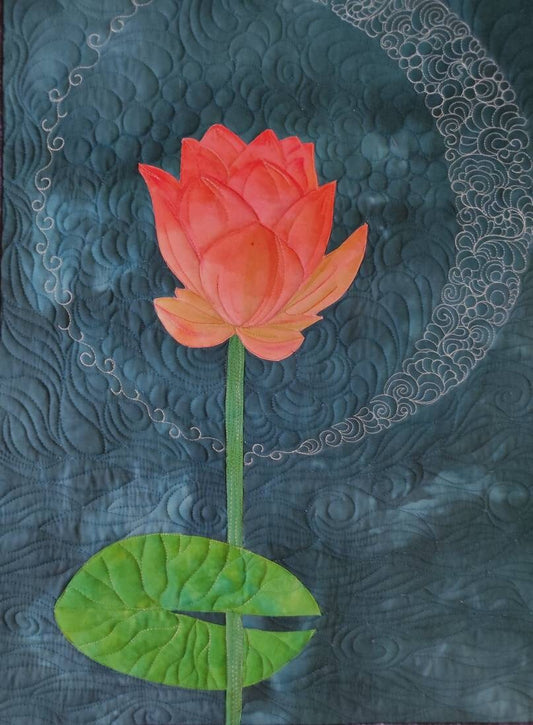 Pink lotus flower under a moon on a blue quilted textile wall hanging