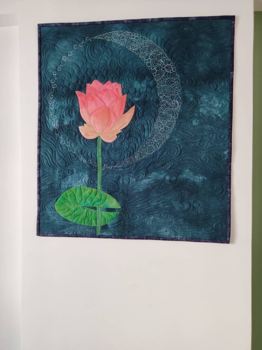Blue and pink art quilt on wall