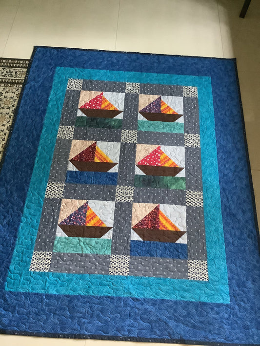 Handmade nautical baby quilt with sailboat