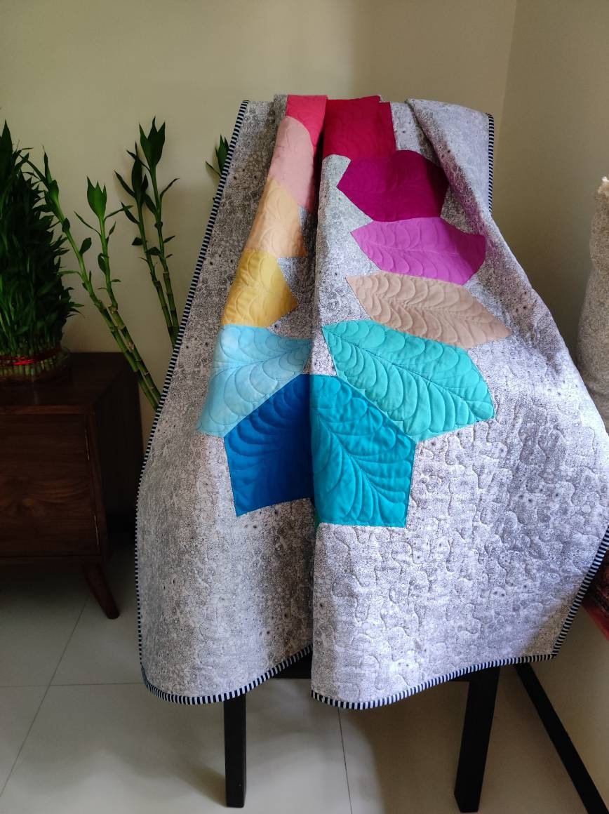 Rainbow quilt folded to show fabric texture