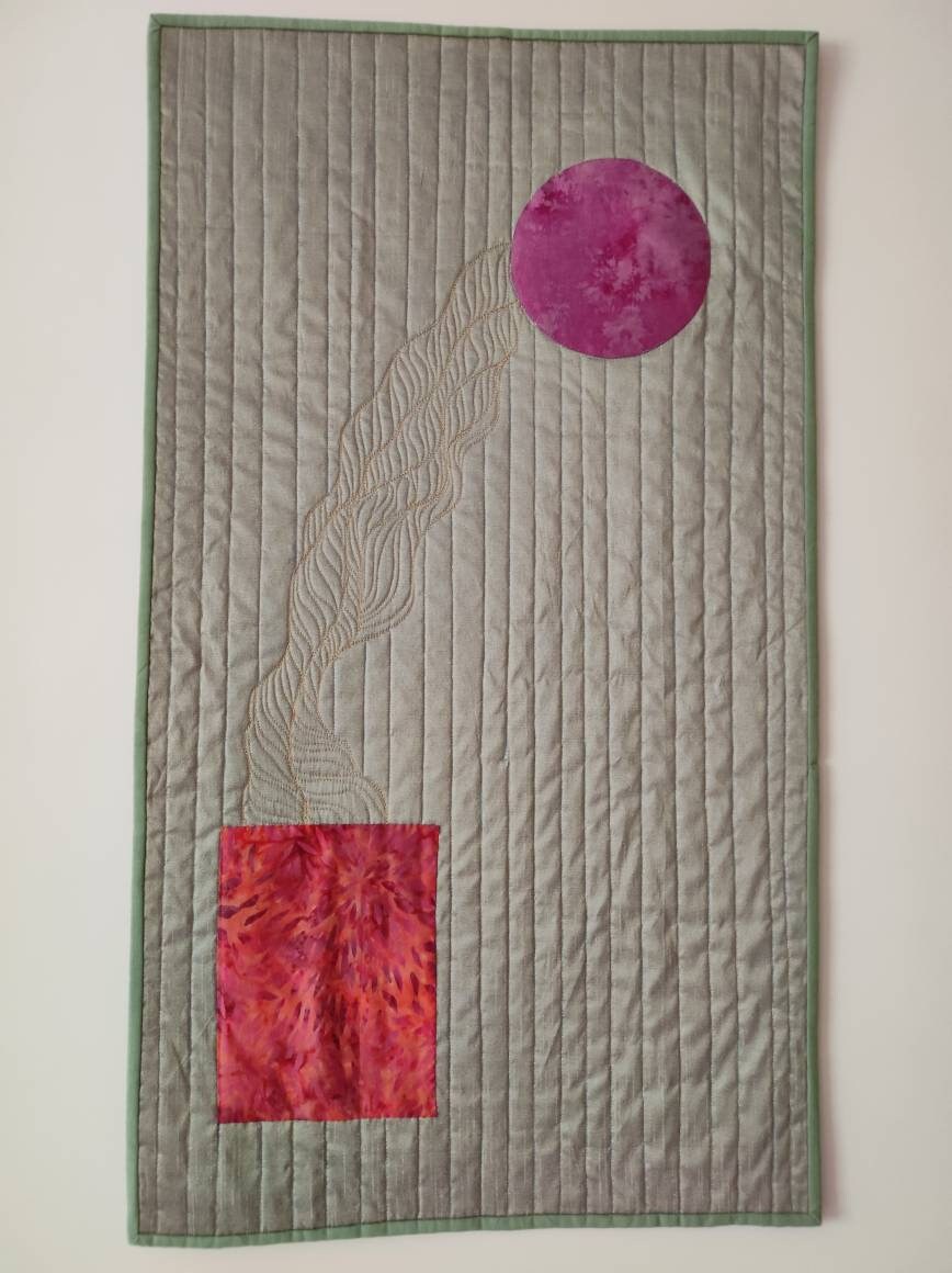 Full view of Silk Walk quilt with purple moon on minimalist silk background