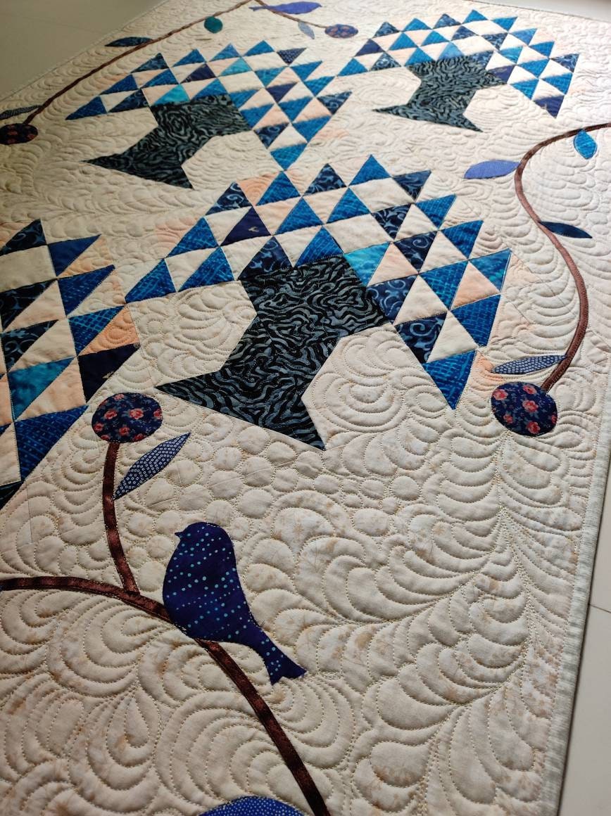 Details of quilting and appliqué on tree of life quilt