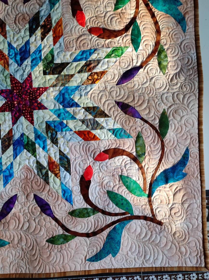 Close up of appliqué and quilting on star quilt