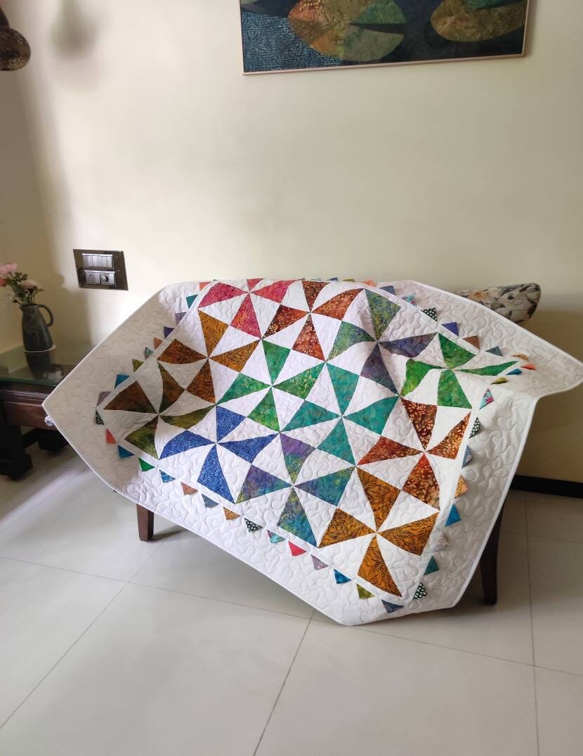 Pinwheel baby quilt on sofa