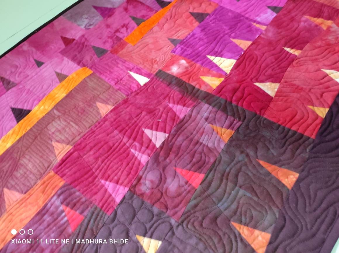 Close-up of hand-dyed fabrics in “Alpenglow” quilt.