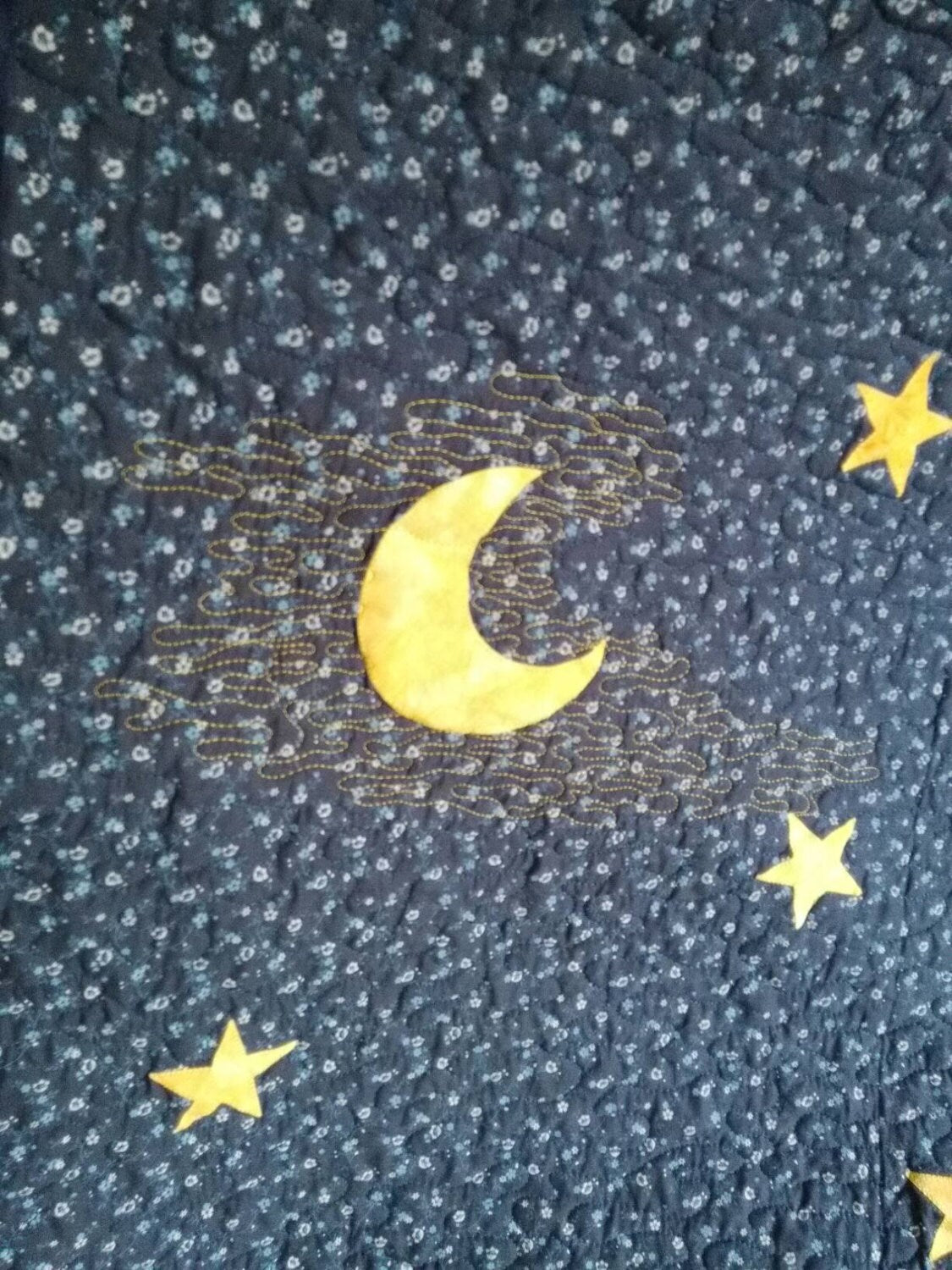 Moon appliqué and quilting details on quilt