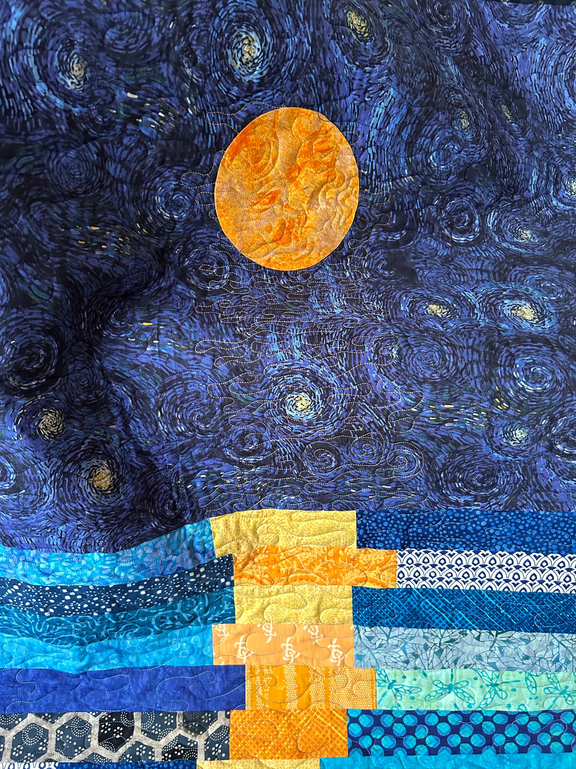 Details on starry night quilt showing moon appliqué 