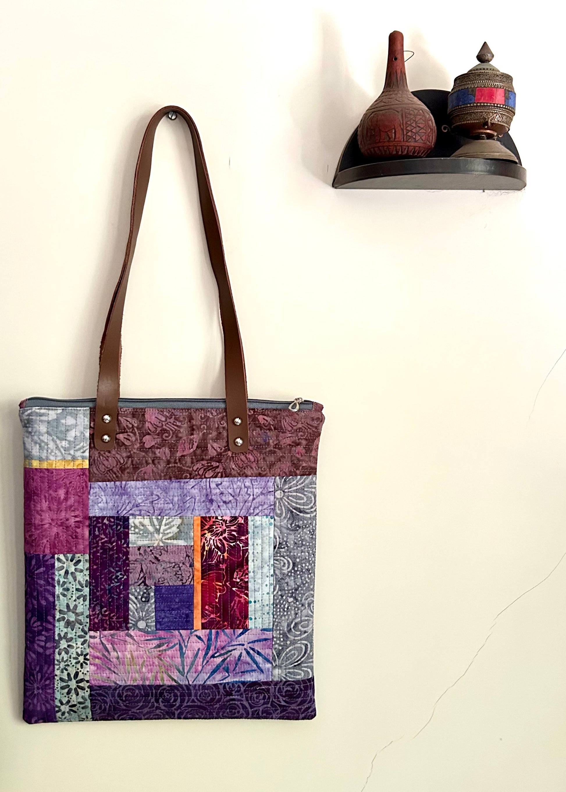 Purple quilted tote bag with leather straps