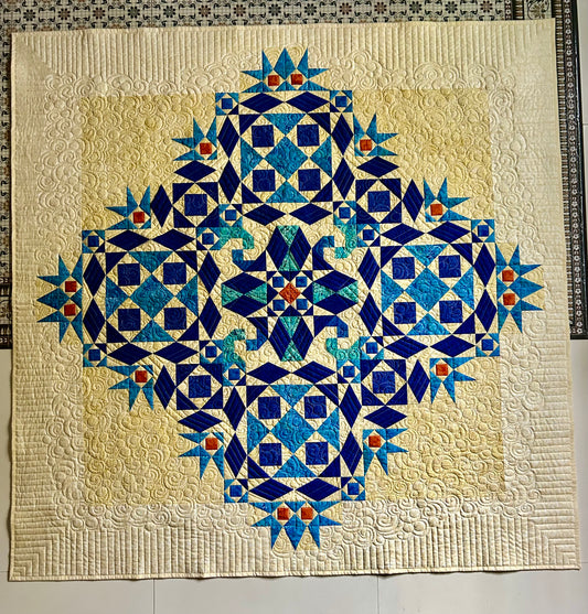 Full-size handmade quilt in blue with ocean wave pattern