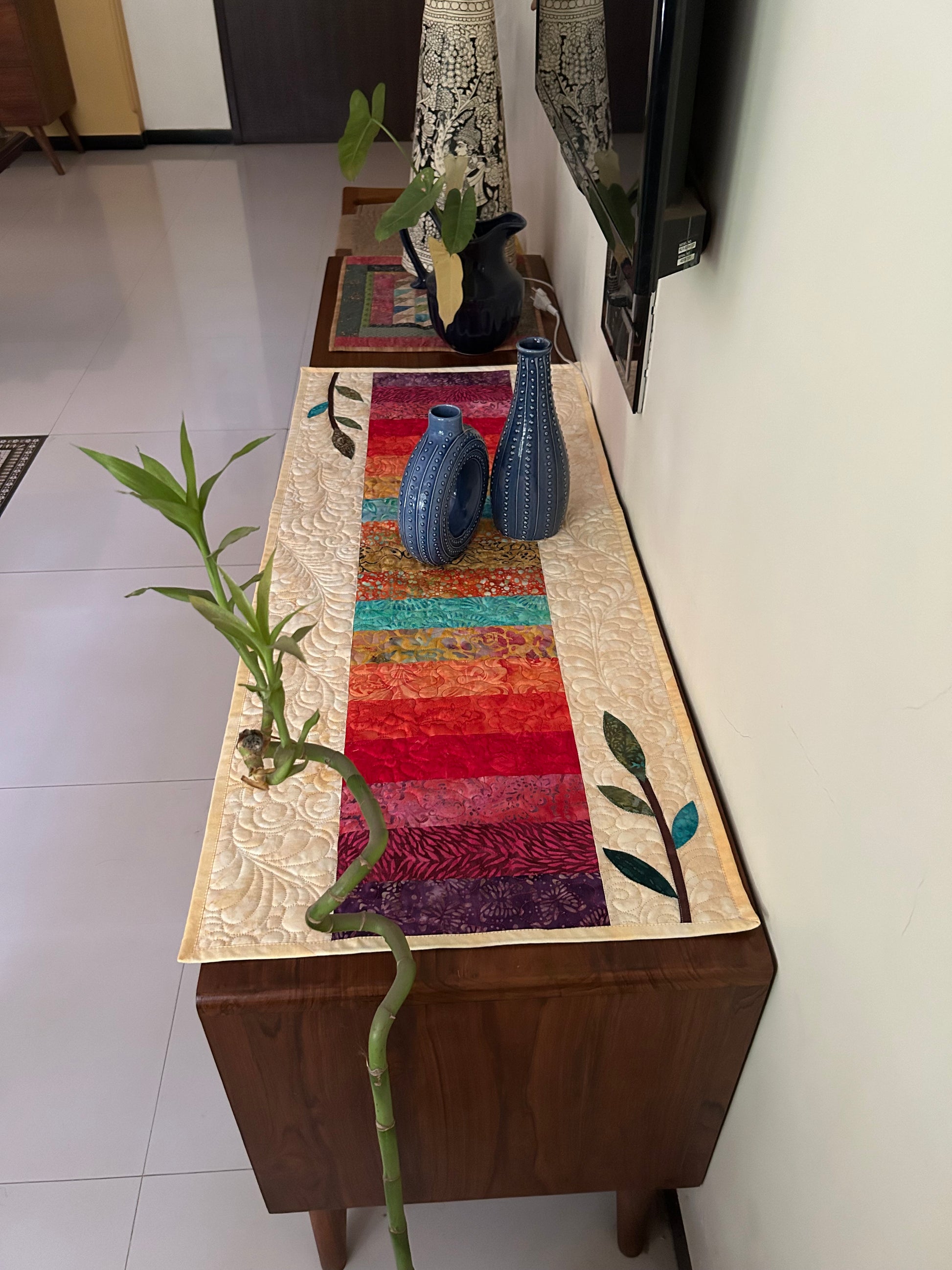 Rainbow quilted table runner on table