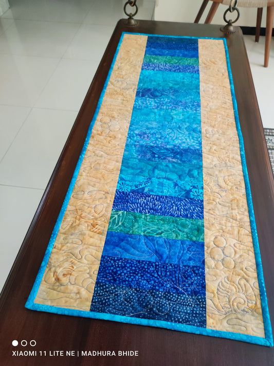 Handmade Ocean-Inspired Quilted Table Runner on wooden swing 