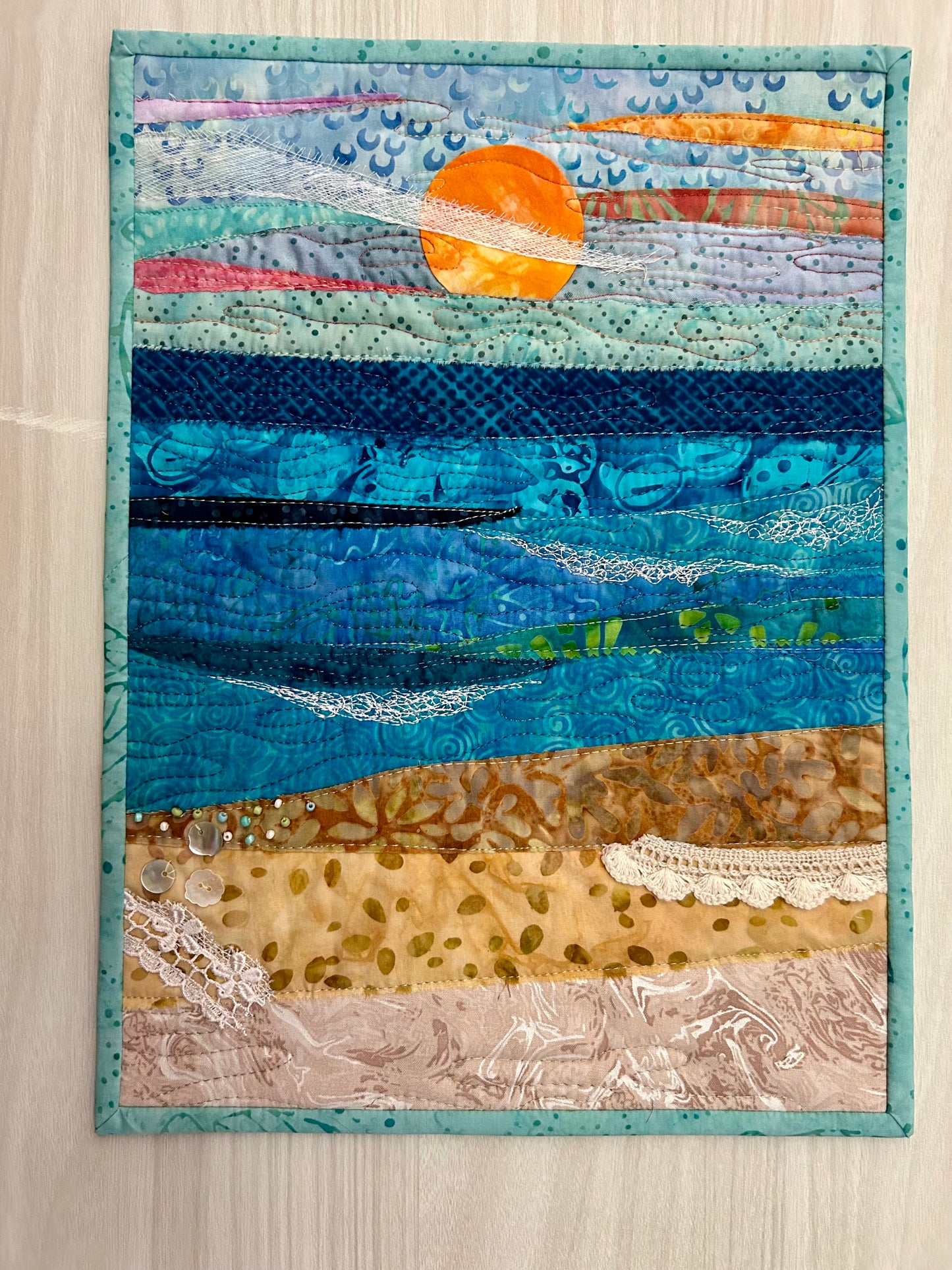 Handmade seascape ocean quilt with beach colors