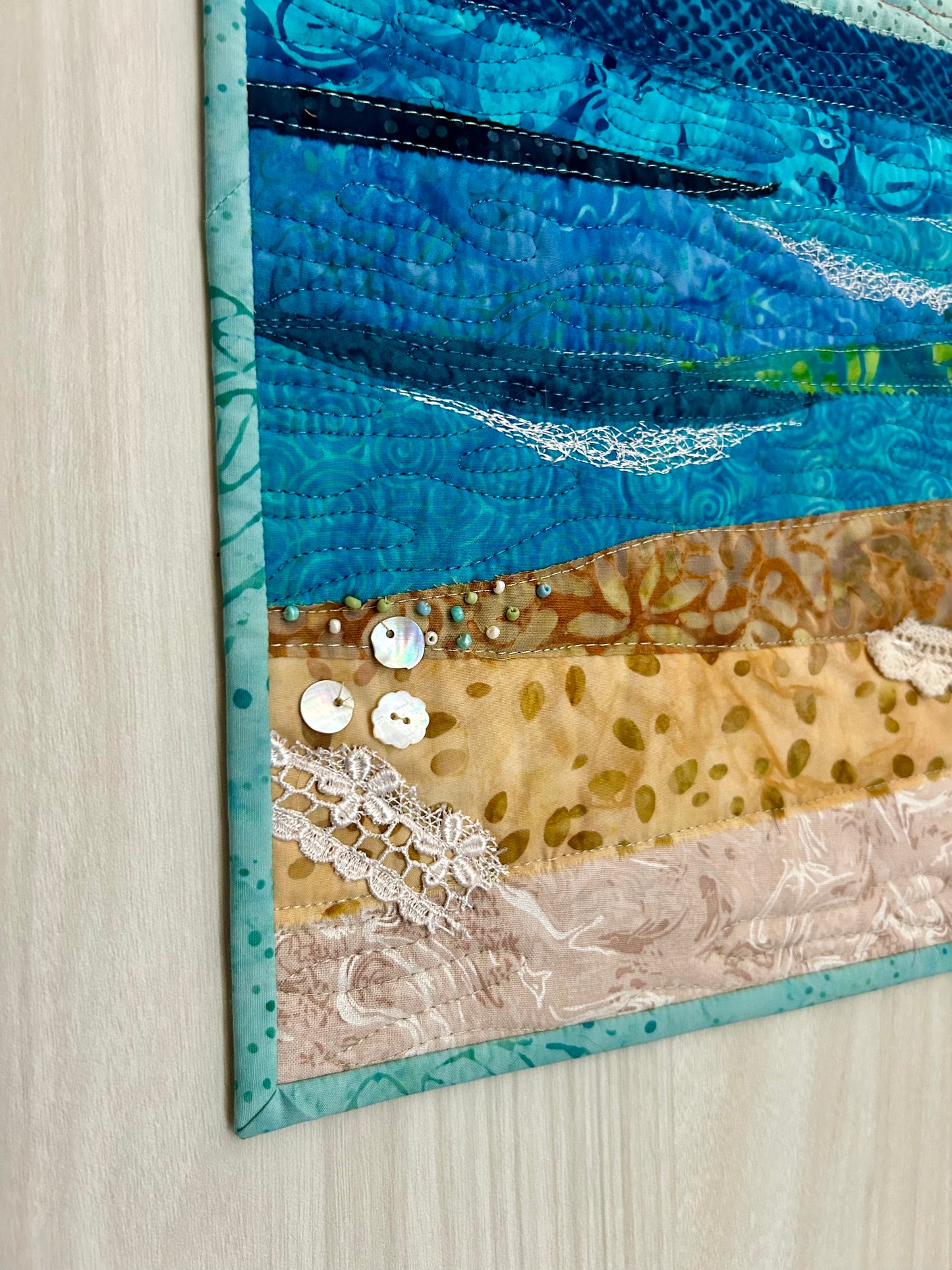 Details of embellishments on ocean art quilt