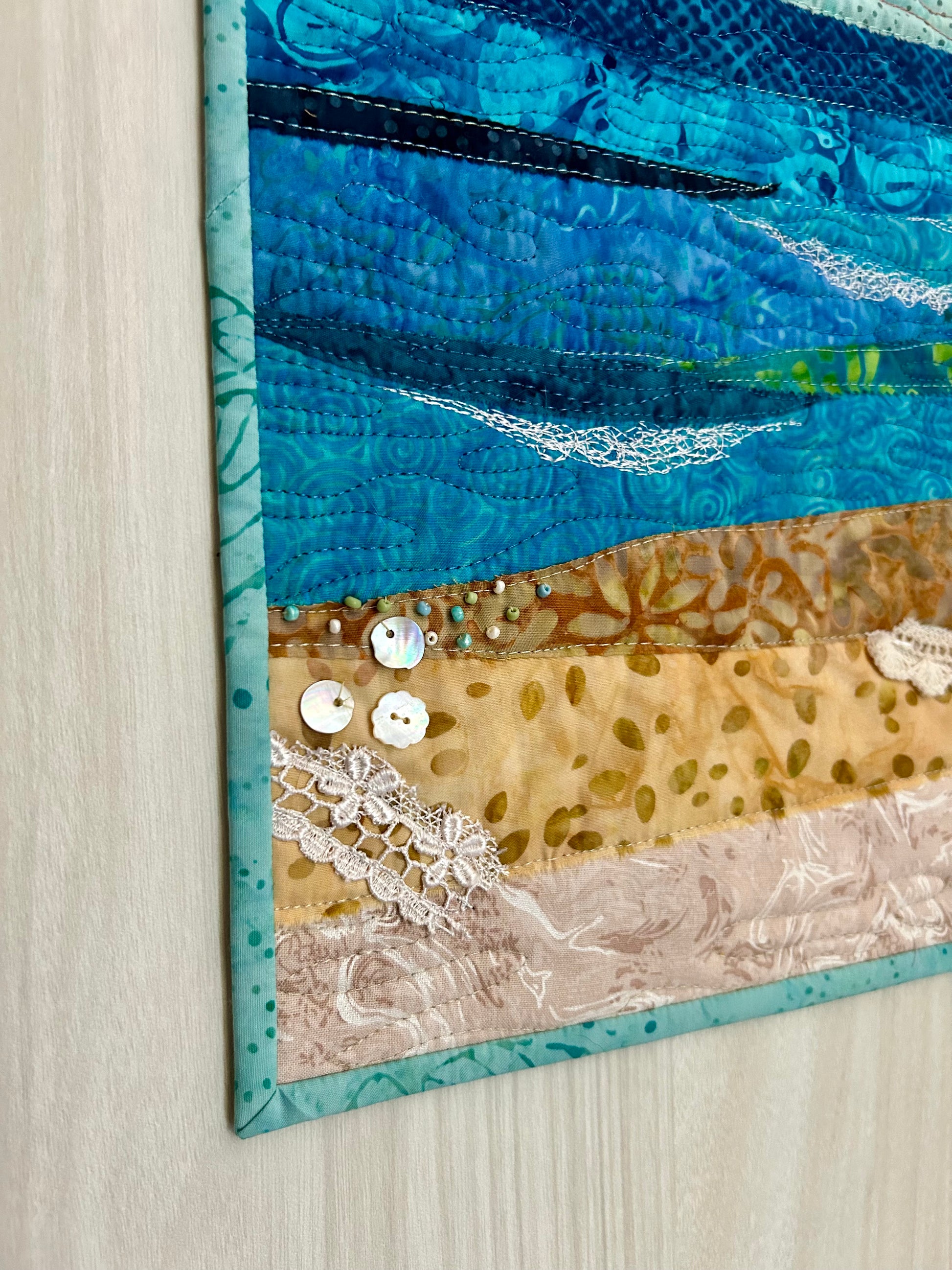 Details of embellishments on ocean art quilt