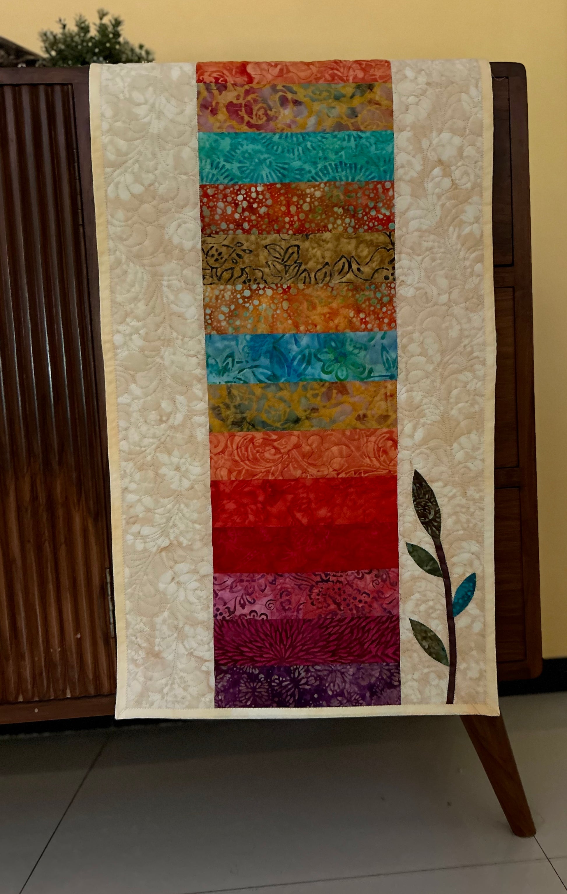 All the rainbow colour batiks in quilted table runner