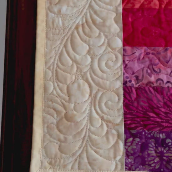 Vide showing details of rainbow quilted table runner
