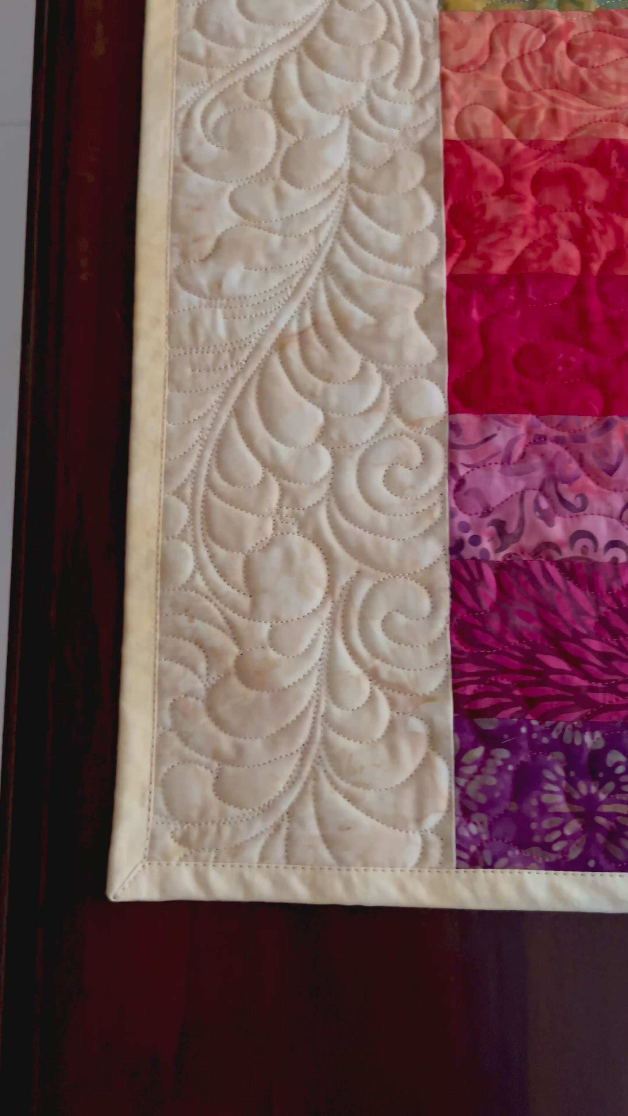 Vide showing details of rainbow quilted table runner