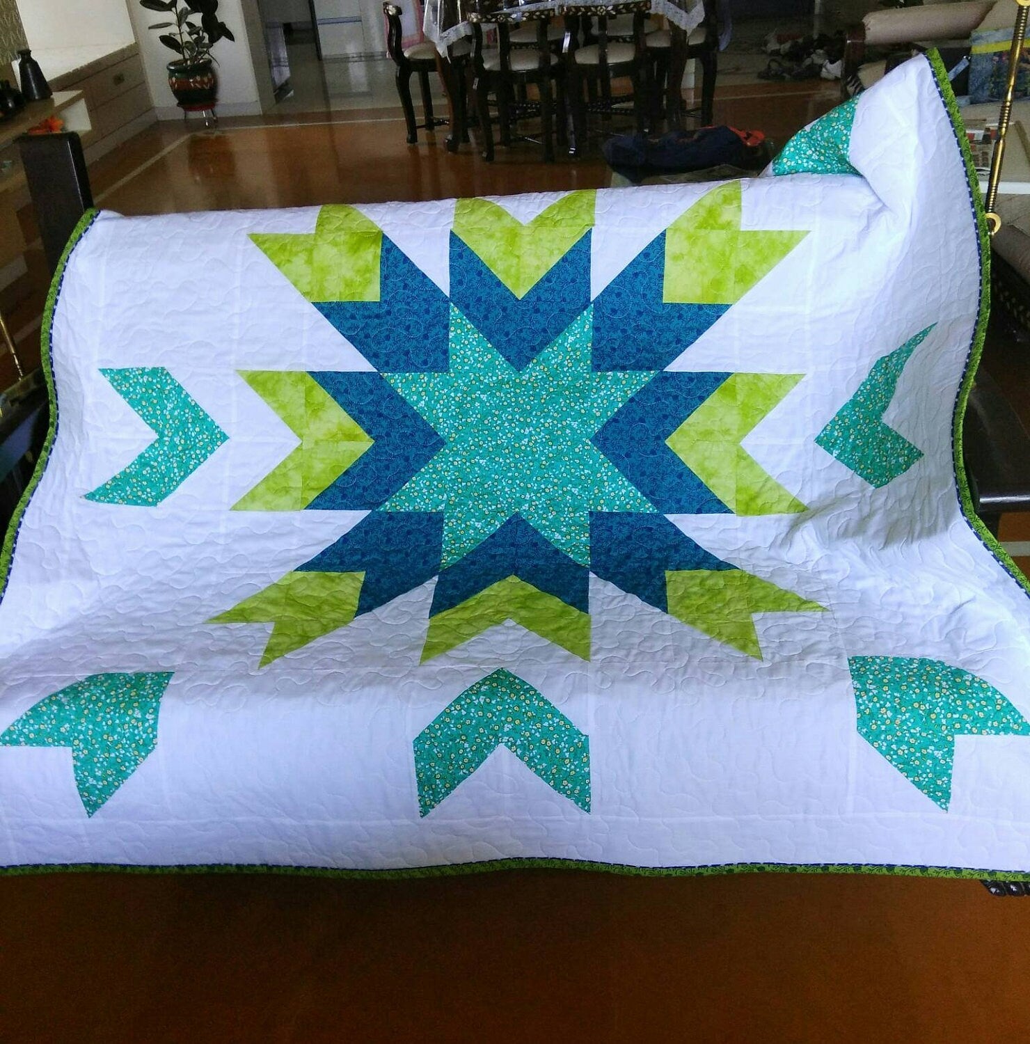 Quilt draped over crib 