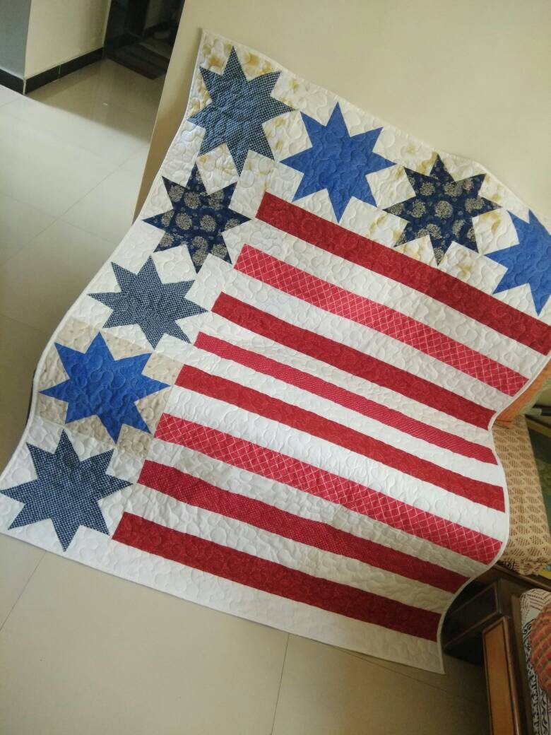 American flag designed patchwork quilt kept on a sofa 