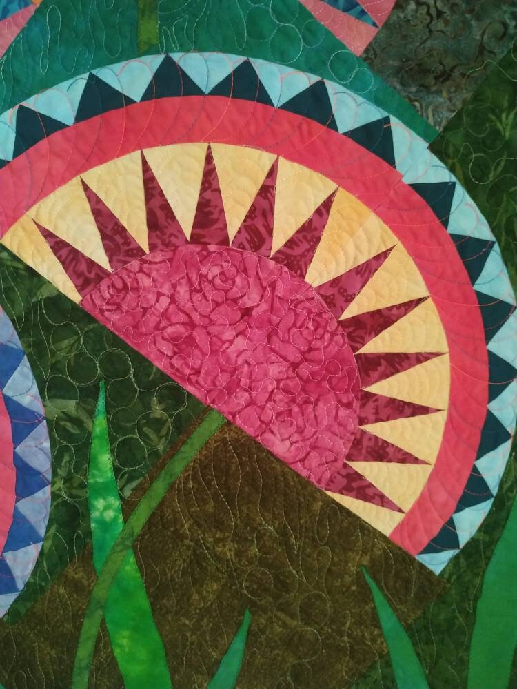 Close up of vibrant fabrics in block of a quilt