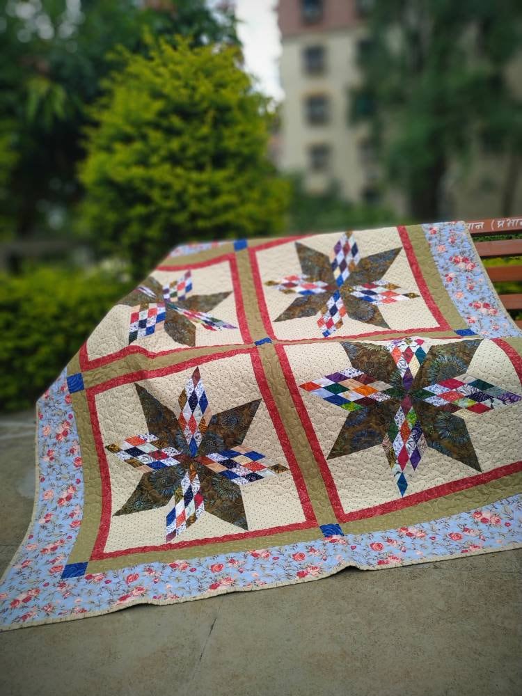 Star throw quilt on a garden bench