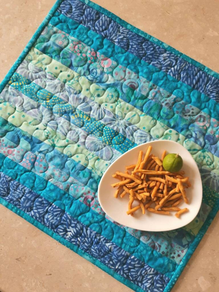 Details of quilting on blue placemats