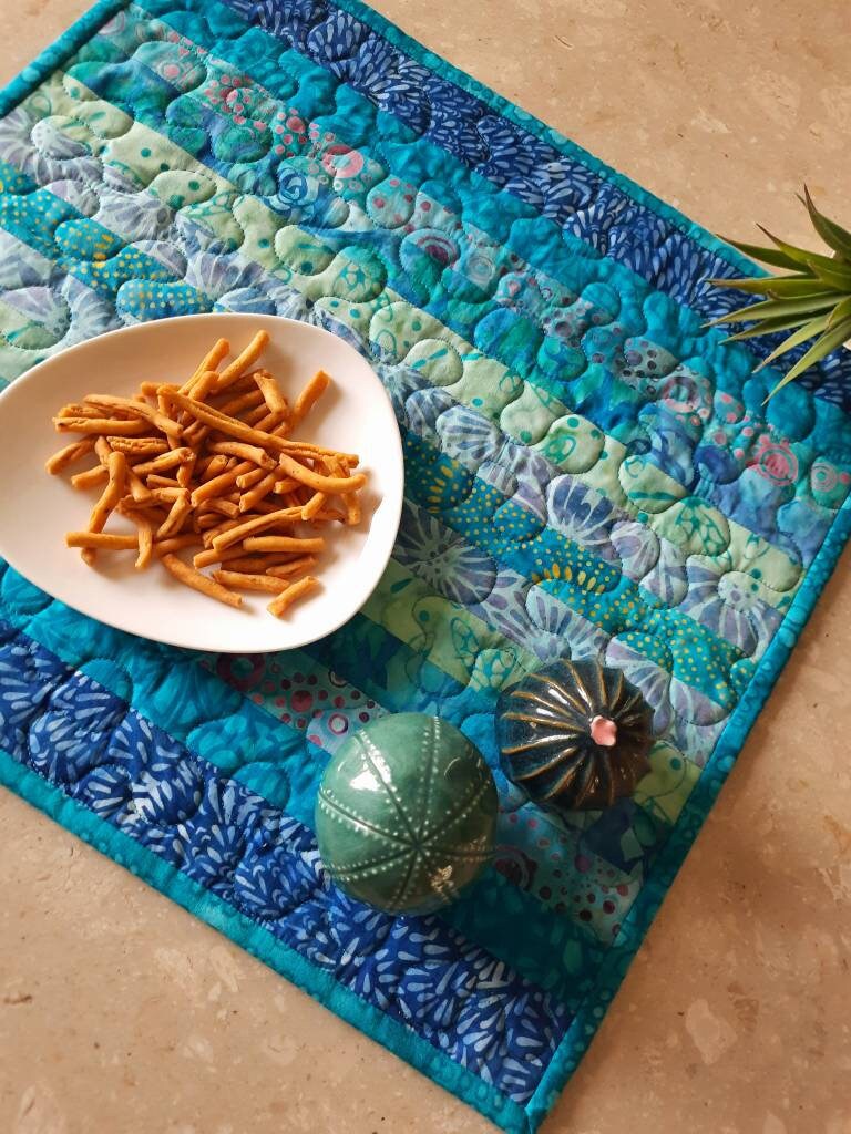Handmade blue placemats styled with dinnerware